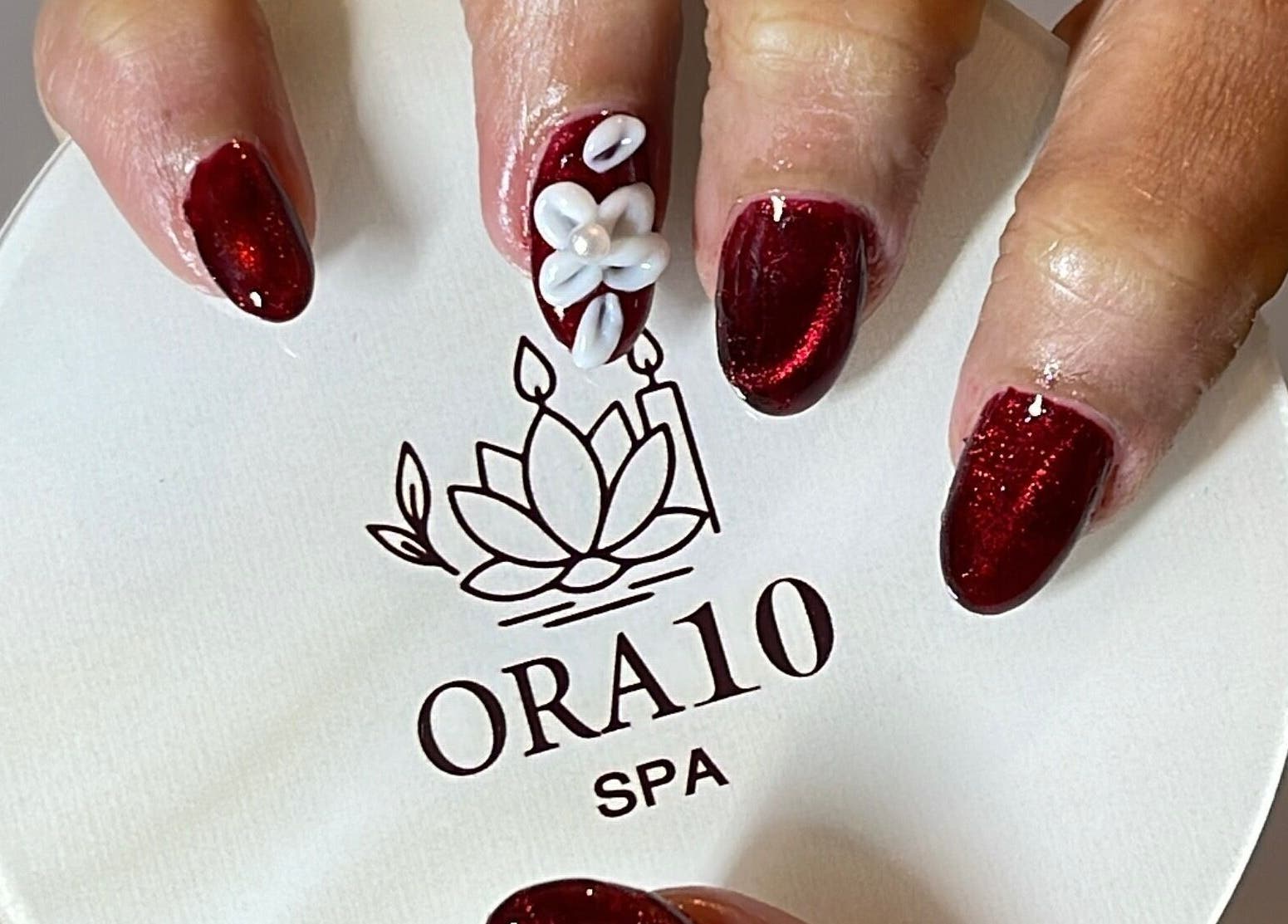 Luxurious nail art with white flower detail at ORA10 SPA - Home Service, Riyadh, Riyadh Province, SA.