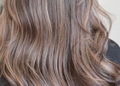 Luxurious wavy hair styled at Olafol Centre De Beauté in Montréal, Québec, CA. Perfect for a chic, modern look.