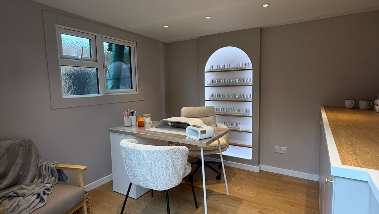 Cozy, elegant nail studio at She's Nailing It, Crawley, England, GB, featuring a stylish workspace with shelves.