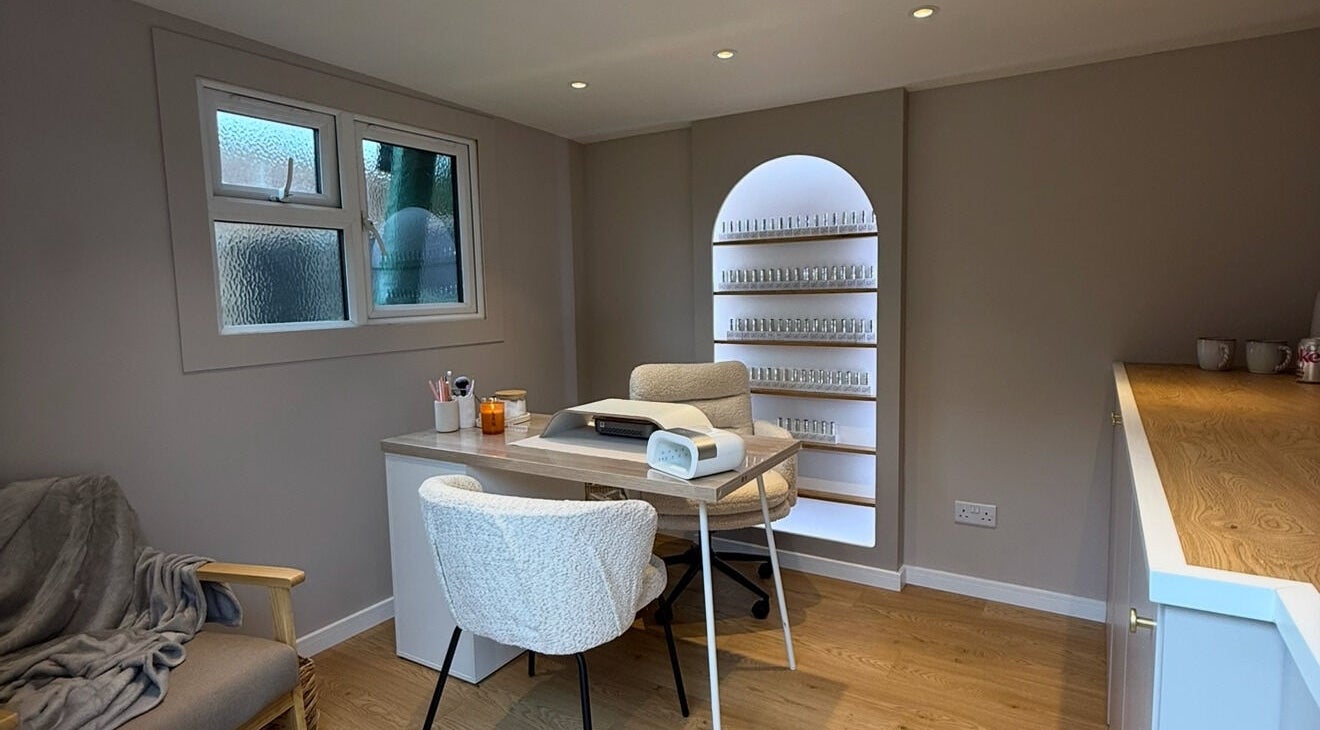 Cozy, elegant nail studio at She's Nailing It, Crawley, England, GB, featuring a stylish workspace with shelves.