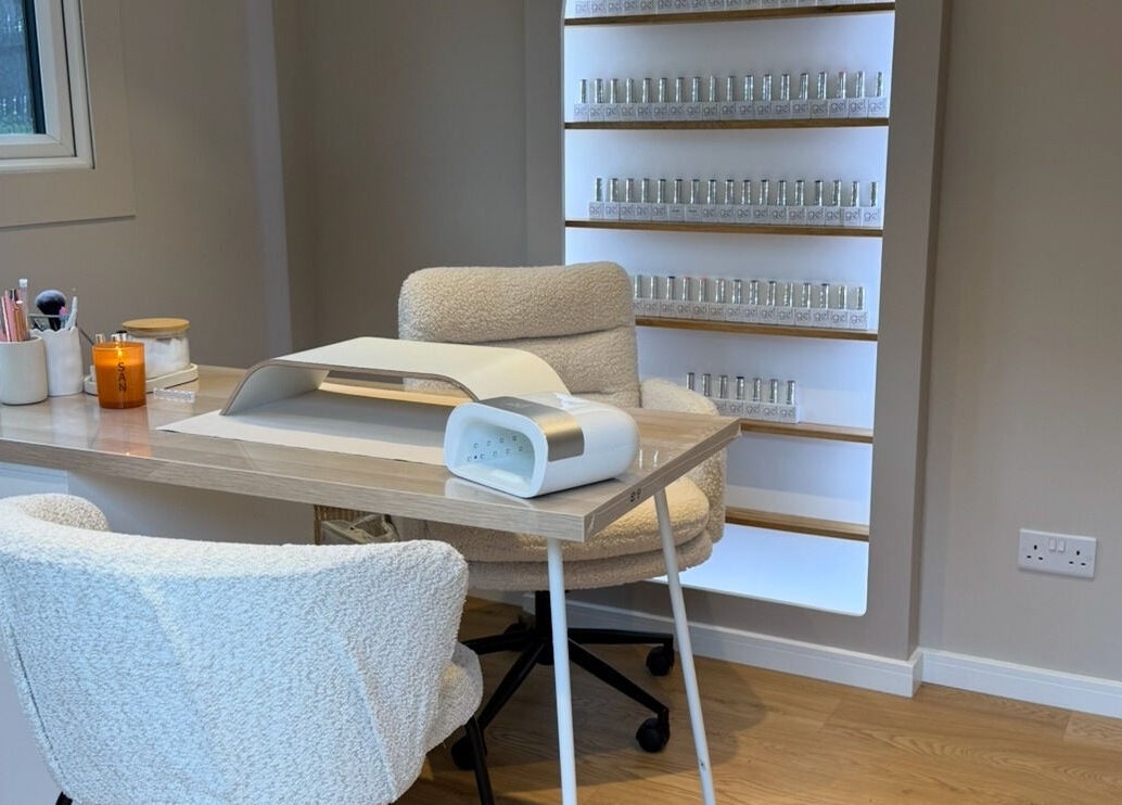 Nail treatment station at She's Nailing It, Crawley, England, GB with cozy chairs and nail polish display.