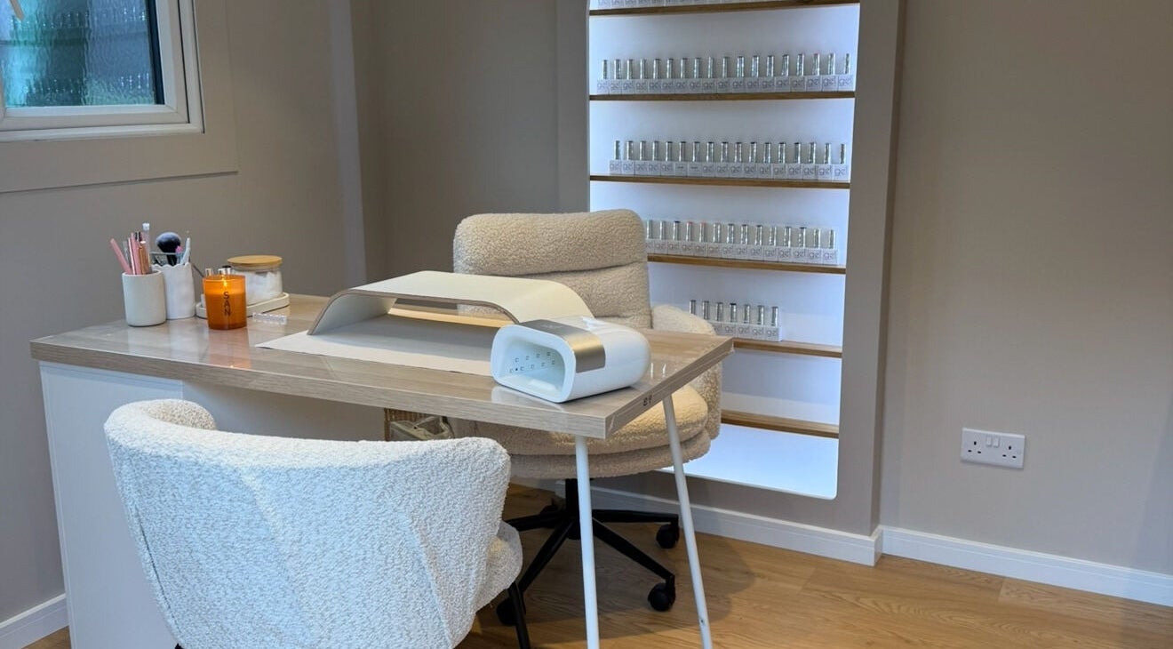 Nail treatment station at She's Nailing It, Crawley, England, GB with cozy chairs and nail polish display.