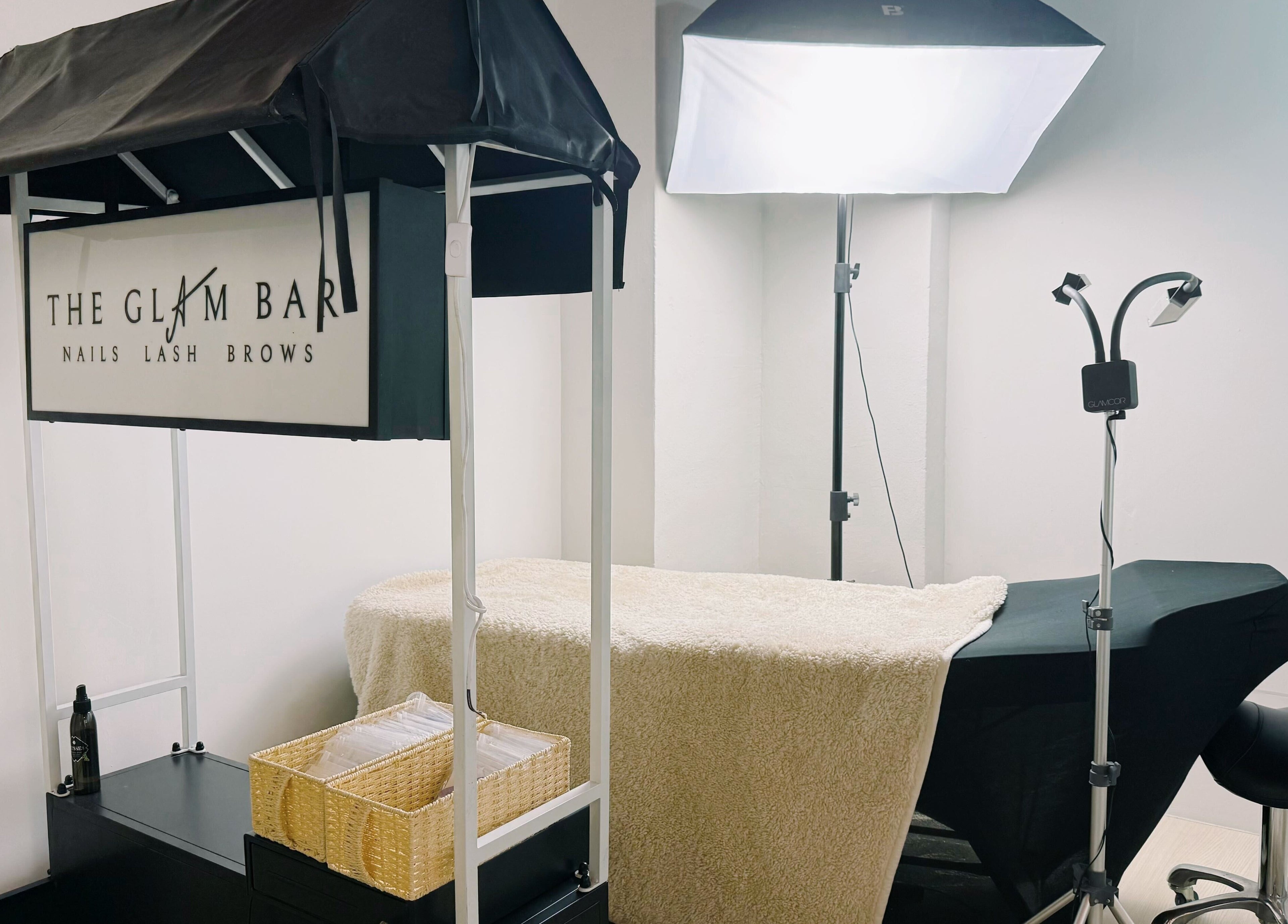 Spa treatment setup at The Glam Bar - Liang Seah, Singapore, Singapore, SG. Featuring cozy decor and professional tools.