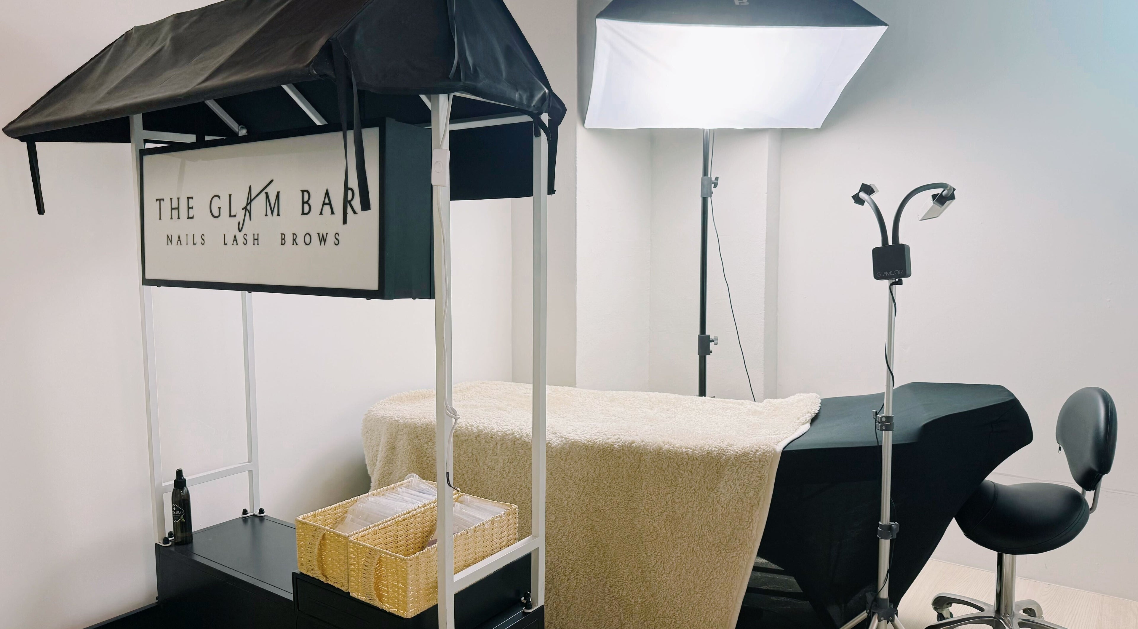 Spa treatment setup at The Glam Bar - Liang Seah, Singapore, Singapore, SG. Featuring cozy decor and professional tools.