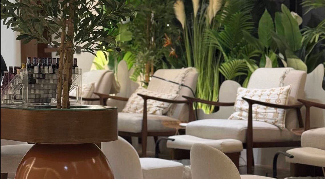 Relaxing seating area at Blend Spa, Sharjah, AE surrounded by lush greenery.