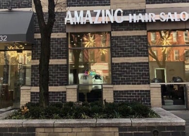 Front exterior of Amazing Hair Salon located in New York, New York, US with stylish brick facade.