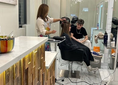 Hairdresser styling a client's hair at Amazing Hair Salon, New York, New York, US.