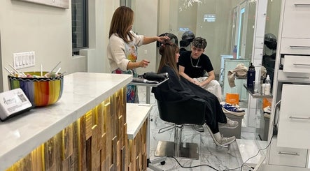 Hairdresser styling a client's hair at Amazing Hair Salon, New York, New York, US.