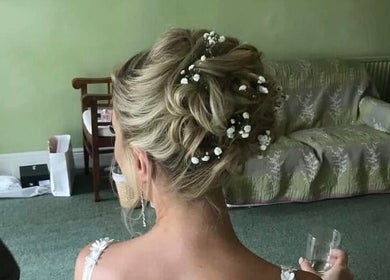 Stunning bridal updo with floral accents at DALA Hair Salon Ammanford, Ammanford, Wales, GB.