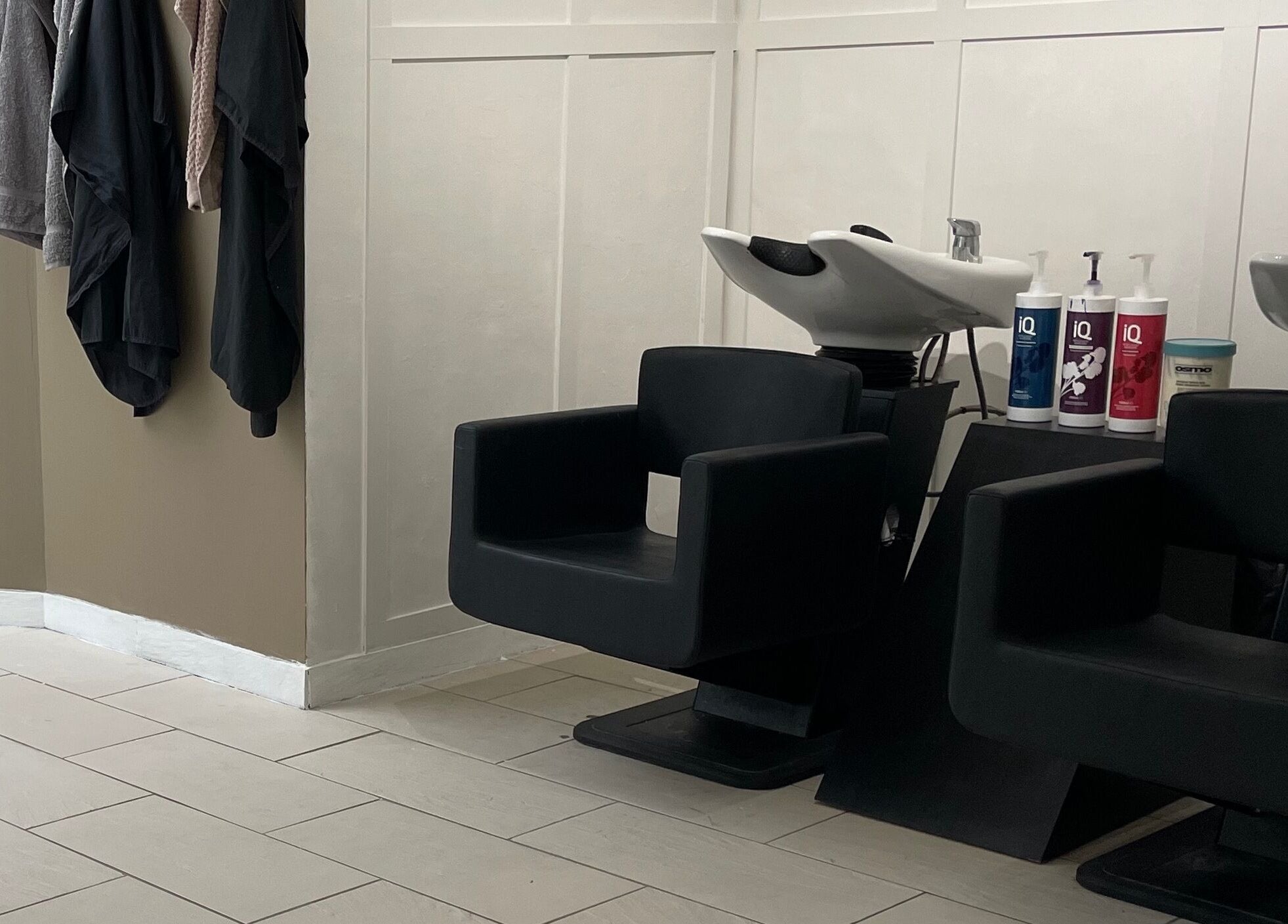 Modern wash stations at Dala Hair Salon Ammanford, Ammanford, Wales, GB, featuring sleek chairs and shampoo.