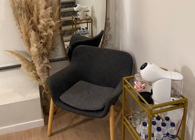 Relaxation nook with chair, plants, and refreshment station at Studio Ilha, Lisboa, Lisboa, PT.