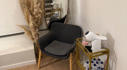 Relaxation nook with chair, plants, and refreshment station at Studio Ilha, Lisboa, Lisboa, PT.