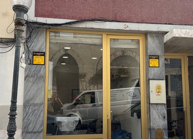 Entrance of Studio Ilha with golden door in Lisboa, Lisboa, PT showcasing modern architecture.