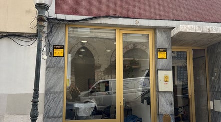 Entrance of Studio Ilha with golden door in Lisboa, Lisboa, PT showcasing modern architecture.
