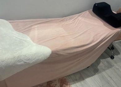 Comfortable treatment bed at Pearlfelt Beauty in Widley, England, GB, ready for a relaxing session.