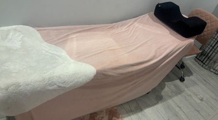 Comfortable treatment bed at Pearlfelt Beauty in Widley, England, GB, ready for a relaxing session.