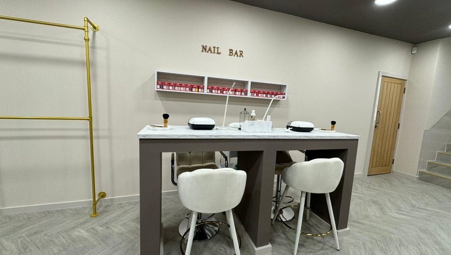 Bisou Studio's chic nail bar interior in Manchester, England, GB with plush seating and elegant decor.