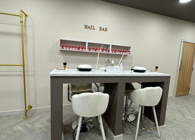 Bisou Studio's chic nail bar interior in Manchester, England, GB with plush seating and elegant decor.