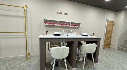 Bisou Studio's chic nail bar interior in Manchester, England, GB with plush seating and elegant decor.