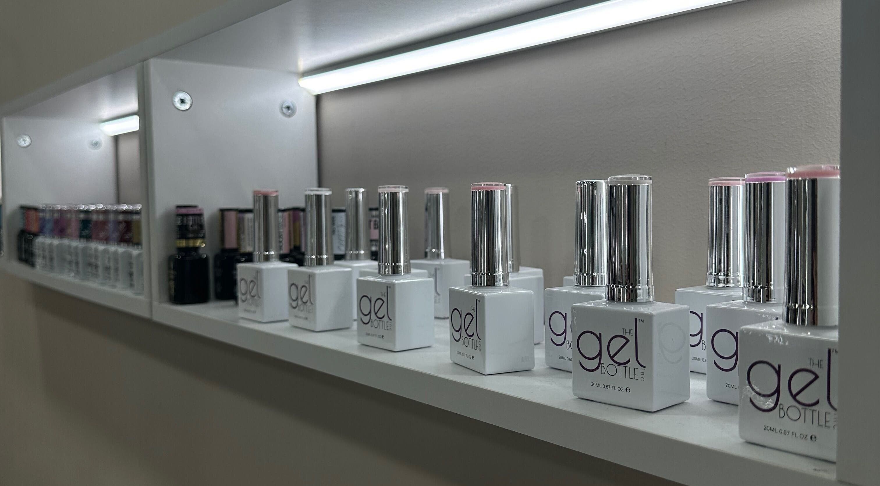 Nail polish display at Bisou Nail Studio, Manchester, England, GB, showcasing a variety of gel colors.