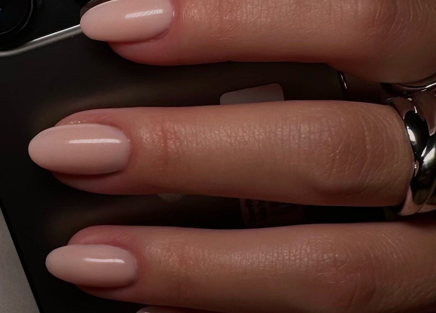 Close-up of manicured nails with a smooth finish at Bisou Nail Studio, Manchester, England, GB.