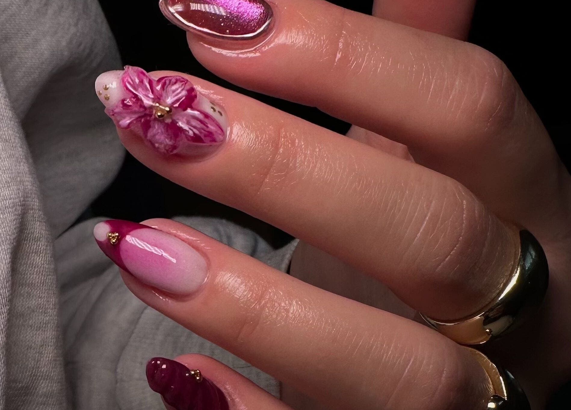 Elegant floral nail art at Bisou Nail Studio, Manchester, England, GB. Beautifully crafted pink designs.
