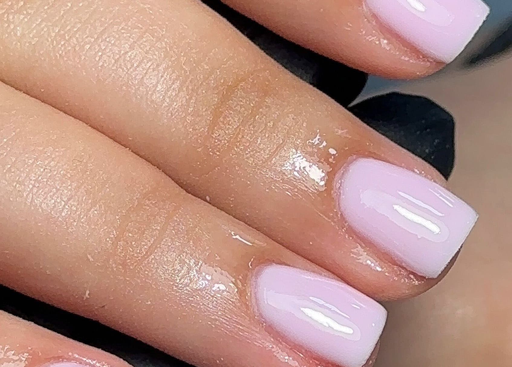 Elegant gel nails at Bisou Nail Studio, Manchester, England, GB, showcasing a beautiful glossy pink finish.