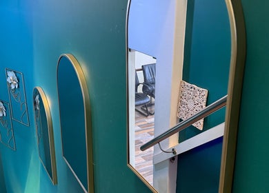 Stylish mirrors accent teal walls at Empire Nails and Beauty Studio, Sandton, Gauteng, ZA enhancing elegance.
