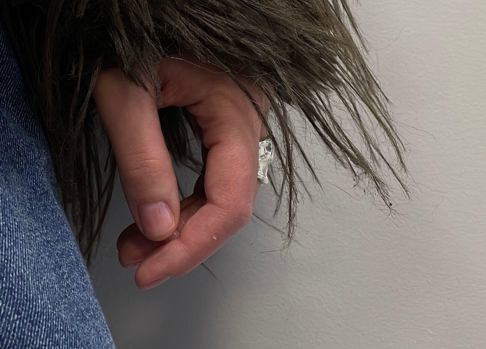 Close-up of hand in denim and fur coat at Stefānija Koltuškina, Rīga, LV.