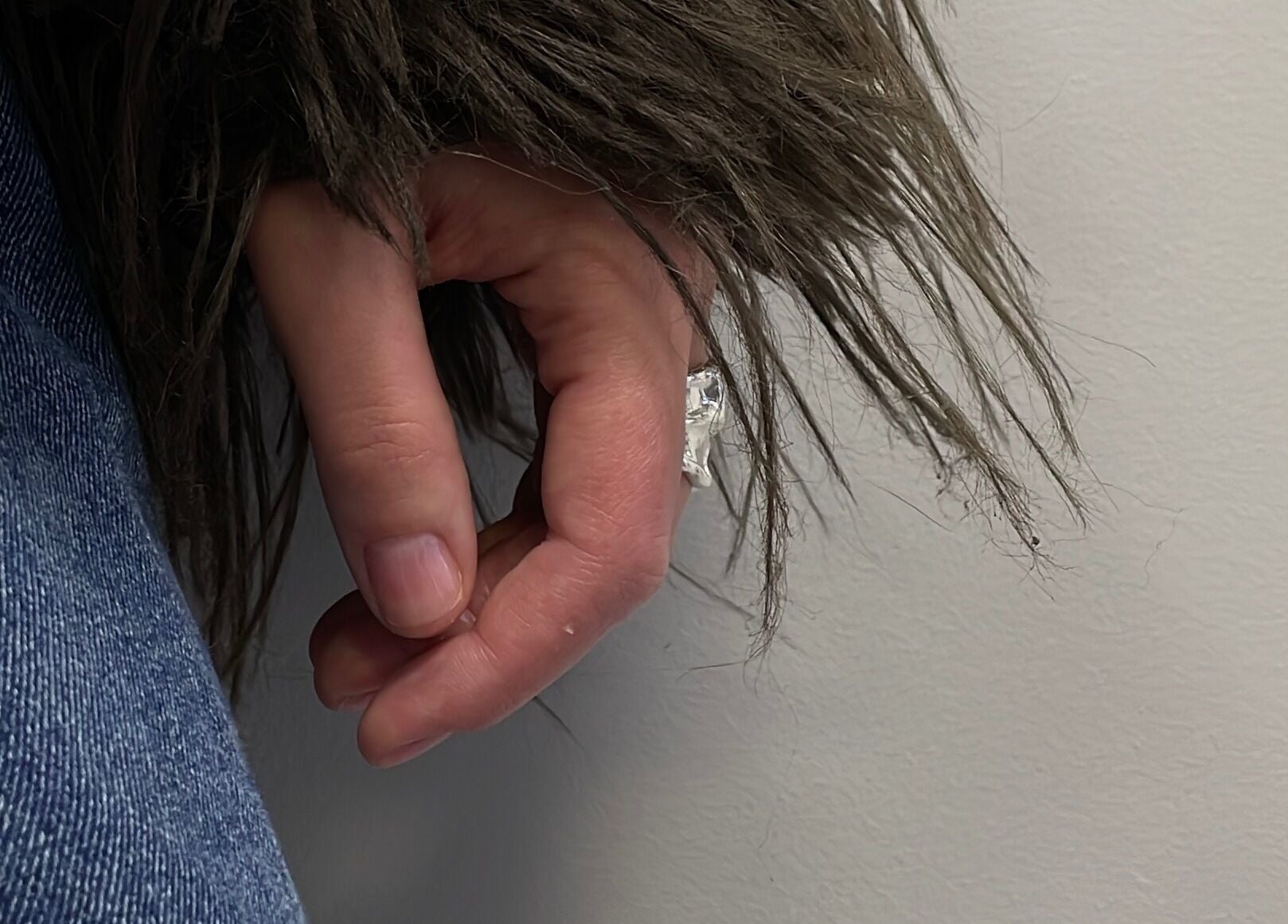 Close-up of hand in denim and fur coat at Stefānija Koltuškina, Rīga, LV.