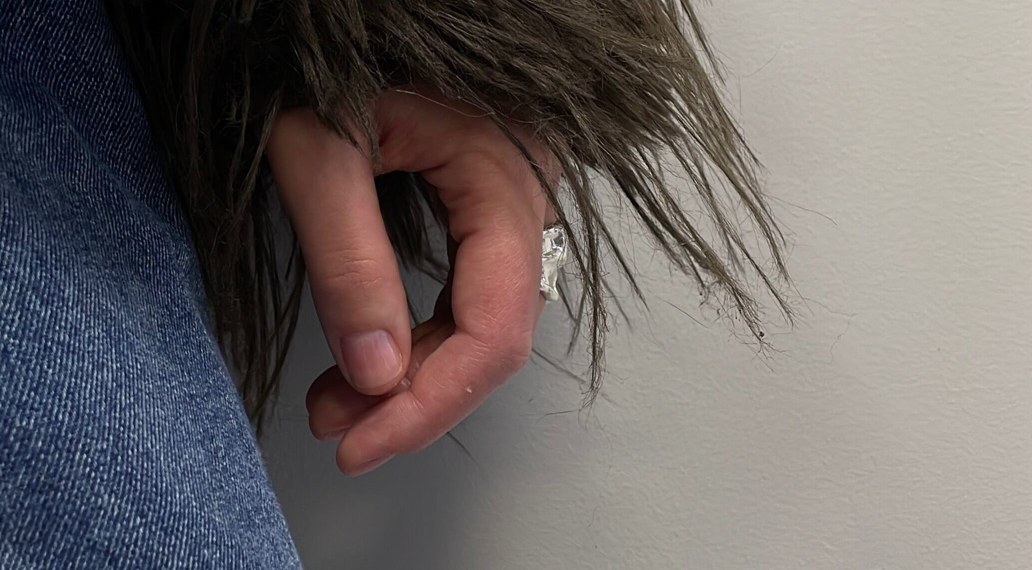 Close-up of hand in denim and fur coat at Stefānija Koltuškina, Rīga, LV.