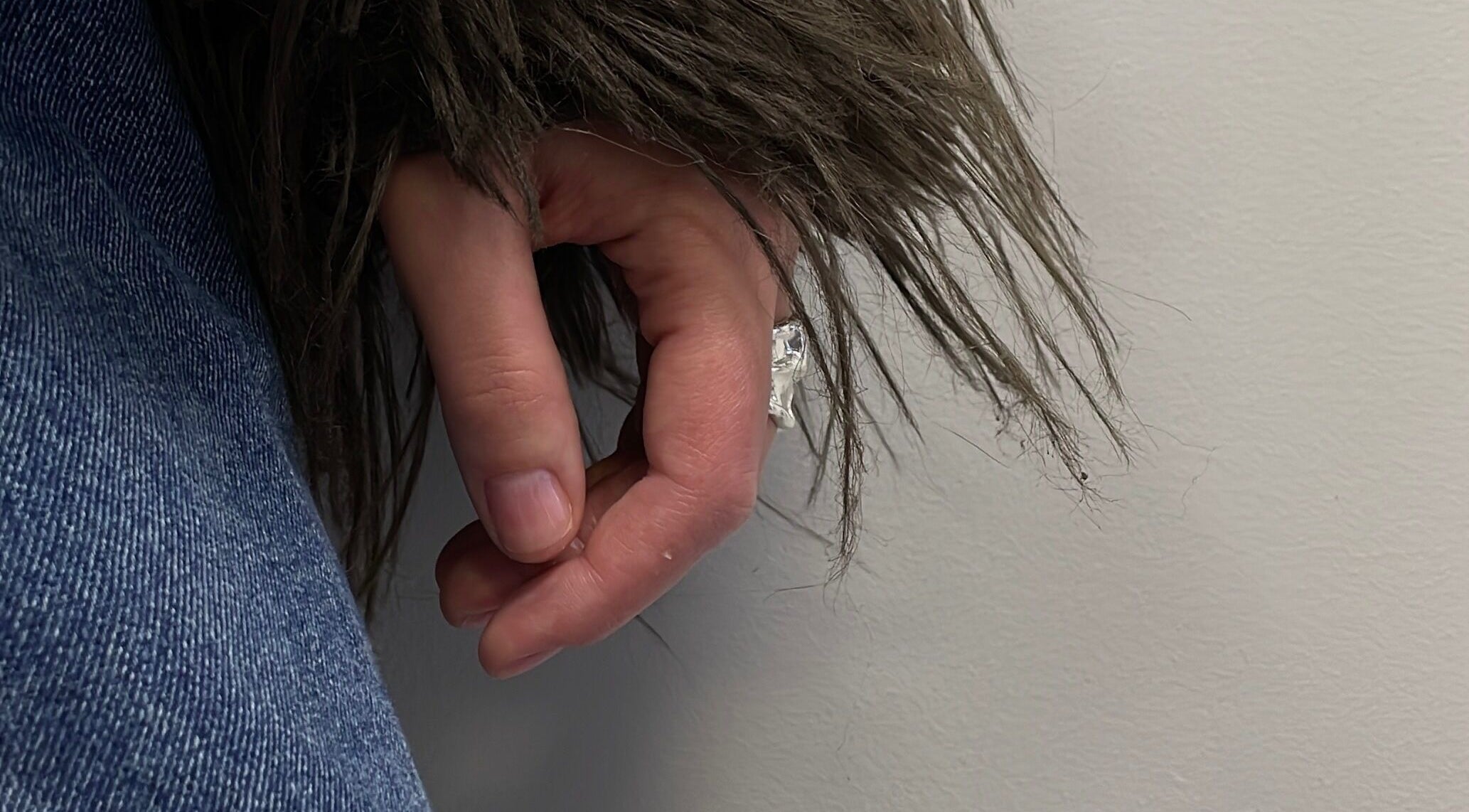 Close-up of hand in denim and fur coat at Stefānija Koltuškina, Rīga, LV.