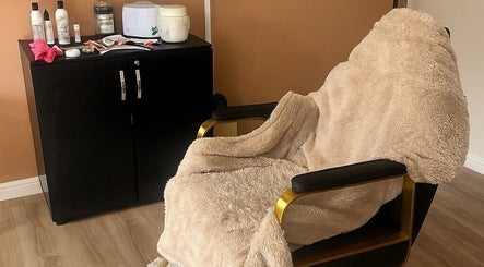 Luxury treatment chair at Beauty Couture & Aesthetic Salon, Leicester, England, GB, with plush throw and products.