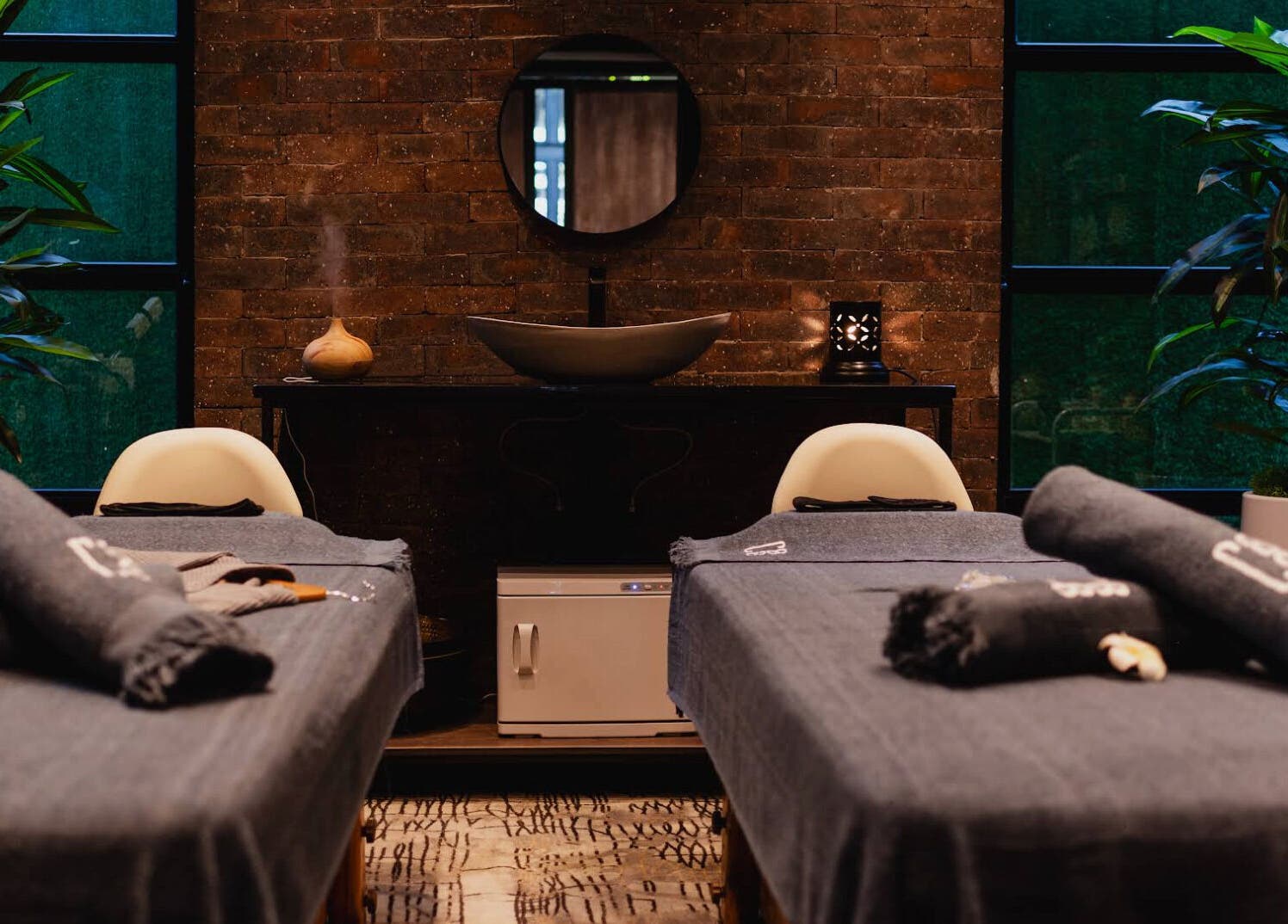 Relaxing massage room at The Spa at Cargo 88, Lusaka, Lusaka Province, ZM, with plush beds and serene lighting.