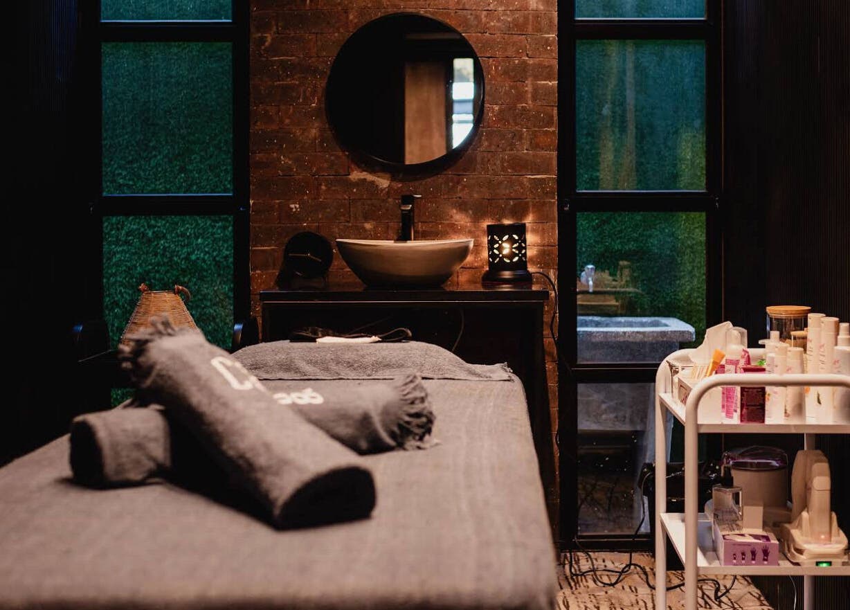Luxurious spa room at The Spa at Cargo 88, Lusaka, Lusaka Province, ZM, featuring a massage bed and skincare products.