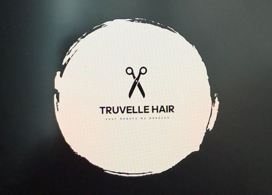 Truvelle Hair salon logo featuring scissors, located in Edensor Park, New South Wales, AU.
