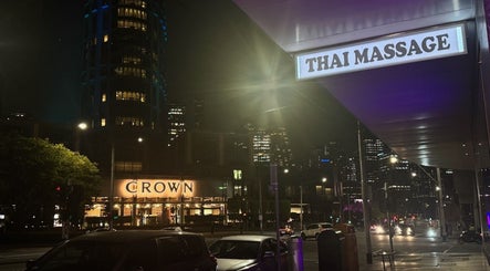ElE Thai Massage sign glowing at night in Victoria, Victoria, AU with city lights in the background.