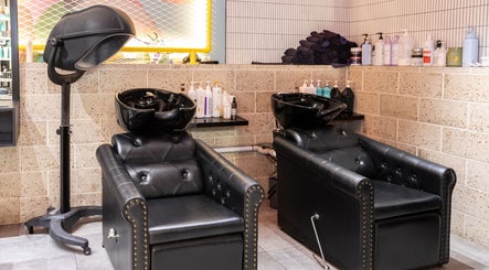 Luxury wash area at Project Hair Salon, Port Adelaide, South Australia, AU with comfortable black chairs.