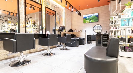 Modern interior of Project Hair Salon in Port Adelaide, South Australia, AU with stylish black chairs.