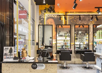 Modern interior of Project Hair Salon, Port Adelaide showcasing stylish decor and product displays.