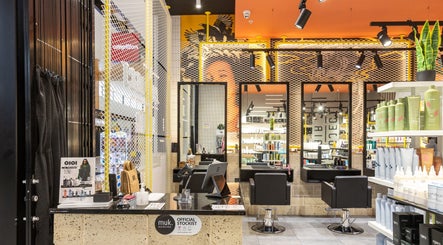 Modern interior of Project Hair Salon, Port Adelaide showcasing stylish decor and product displays.