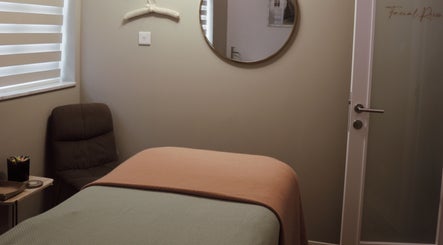 Cozy treatment room at Antonia Formosa Skin Therapist, St Julian's, MT, with a massage table and mirror.