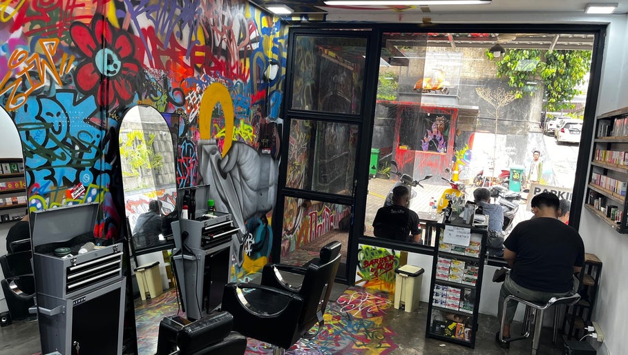 Interior Barberhop di Daerah Khusus Ibukota Jakarta dengan seni grafiti yang hidup dan kontemporer.