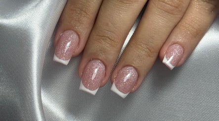 Close-up of shimmering French manicure at Nailed by Kuki, Willemstad, CW.