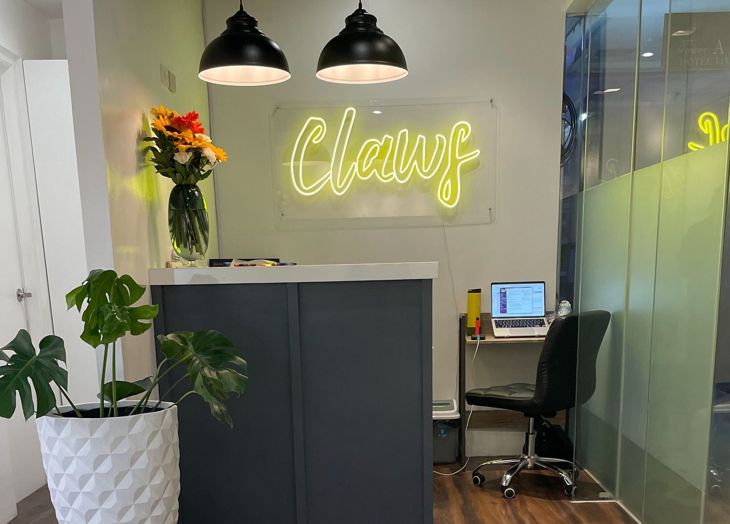 Reception area at Claws Studio, Mandaluyong City, Metro Manila, PH with neon signage and decor.