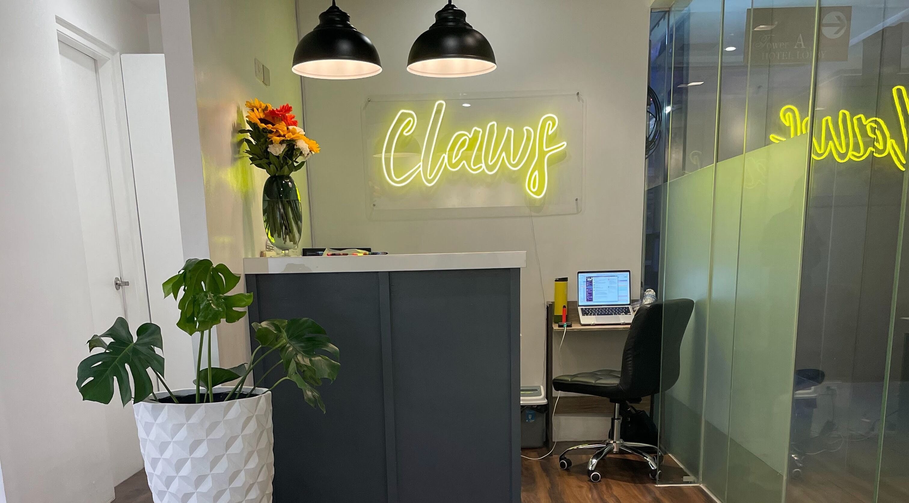 Reception area at Claws Studio, Mandaluyong City, Metro Manila, PH with neon signage and decor.