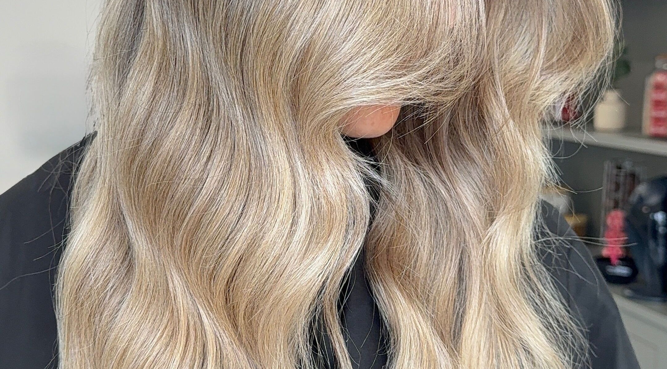 Smooth wavy blonde hairstyle at Paigelouisehair in Derby, England, GB.