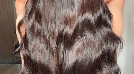 Smooth, shiny brown hair at Paigelouisehair, Derby, England, GB, showcasing expert styling.