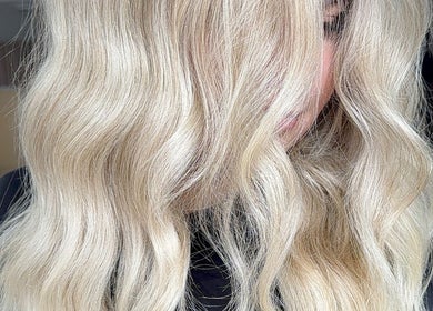 Elegant blonde waves styled at Paigelouisehair in Derby, England, GB. Perfect for a sophisticated look.