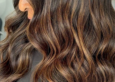 Glossy brown wavy hairstyle at Paigelouisehair, Derby, England, GB, showcasing professional beauty services.